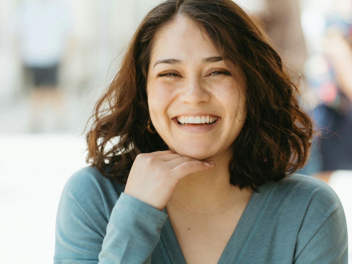 a lady with healthy smile confidently smiling