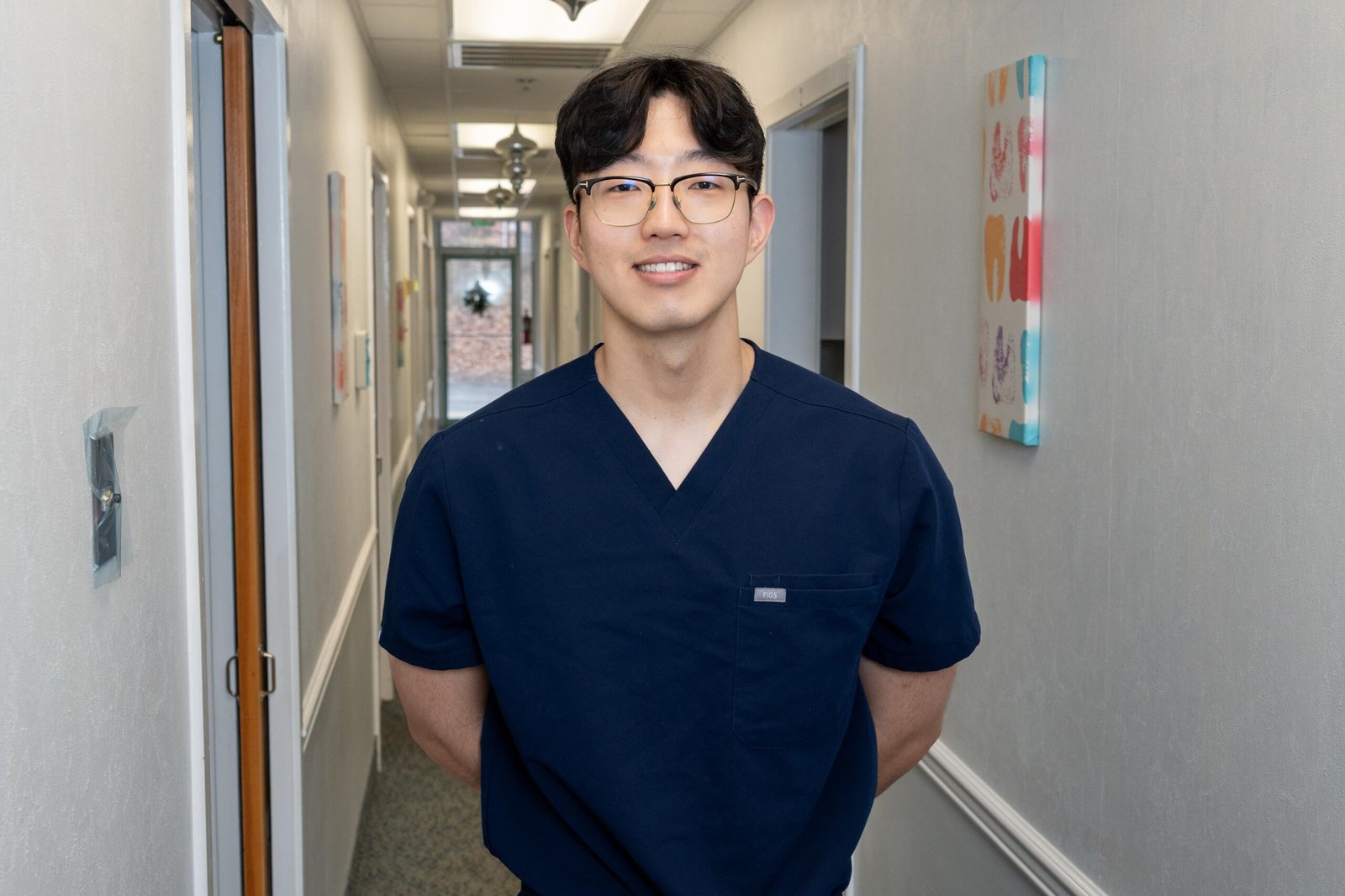 Dr. Geon Nam Of Oracore Dental, Trusted Family Dentist in Odenton MD, wearing blue scrubs