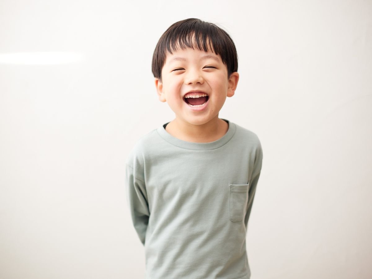 Child boy with a healthy, restored smile after restorative dentistry treatment at OraCore Dental