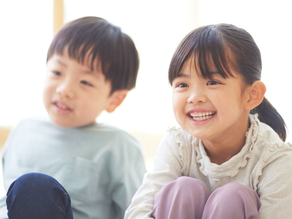 Two happy kids smiling after a pediatric dentistry visit at OraCore Dental in Odenton, MD