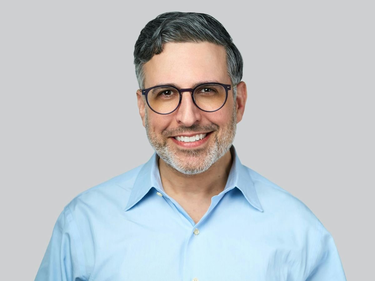 A confident smiling man after cosmetic dentistry treatment at OraCore Dental in Odenton, MD, highlighting professional dental care focused on improving oral health, appearance, and natural-looking smile results.