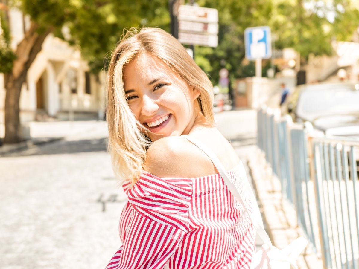 Confident woman with a healthy smile after comprehensive restorative dental care at OraCore Dental